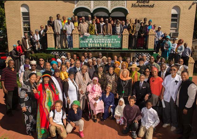 Photo of large crowd of MAVA supporters gathered in front of Masjid Muhammad for a group photo